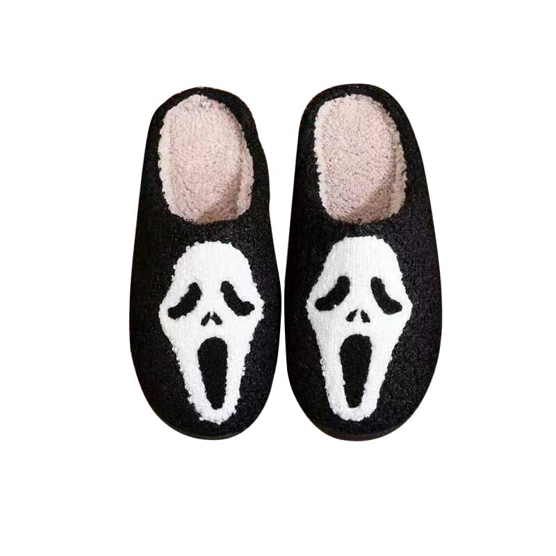 A stack of women's plush house slippers, featuring various pumpkin and ghost designs.