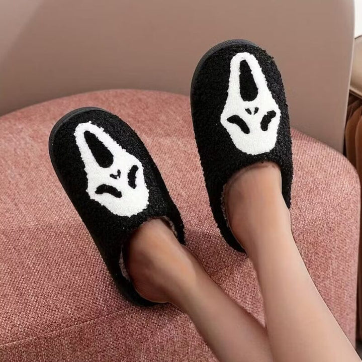 Side view of a women's plush pumpkin slipper, highlighting the comfortable, soft material.