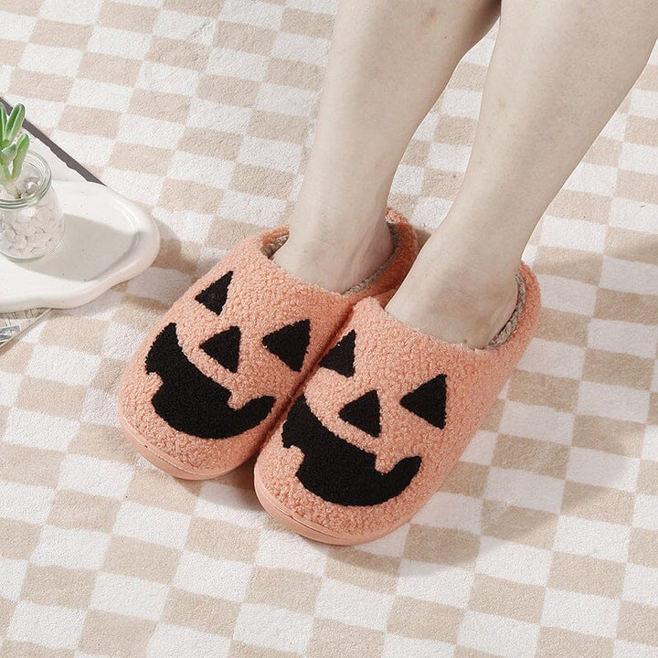 Women's autumn house slippers, fleece-lined and plush with a fun pumpkin icon.