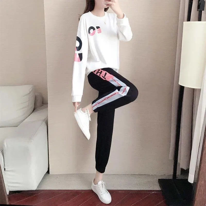Sporty women's two-piece tracksuit, versatile for activewear or loungewear, includes a comfy sweater & pants.