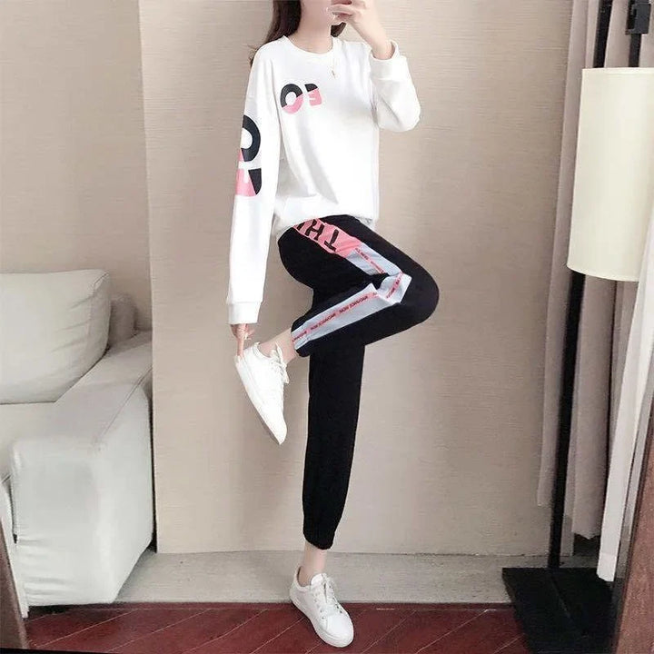 Sporty women's two-piece tracksuit, versatile for activewear or loungewear, includes a comfy sweater & pants.