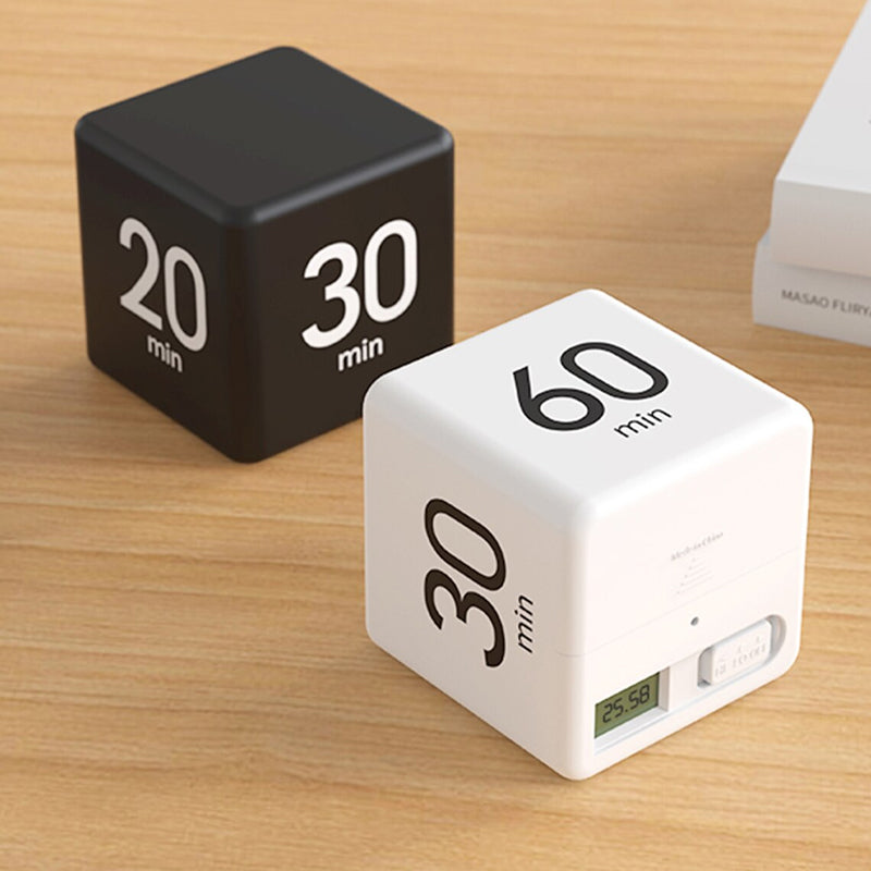 Hands placing a cube timer on a desk, ready for a productive work session