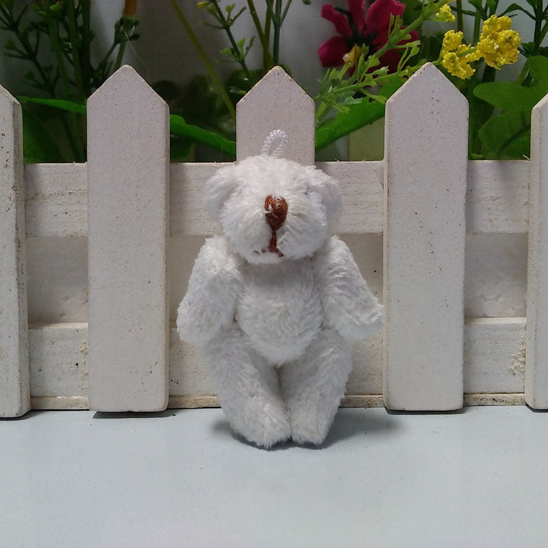Pocket bear plush toy keychain holding a tiny paper scroll with an uplifting message for encouragement.