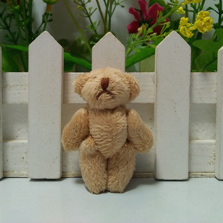 Group of various colored pocket bear plush toy keychains, each with an encouraging message.