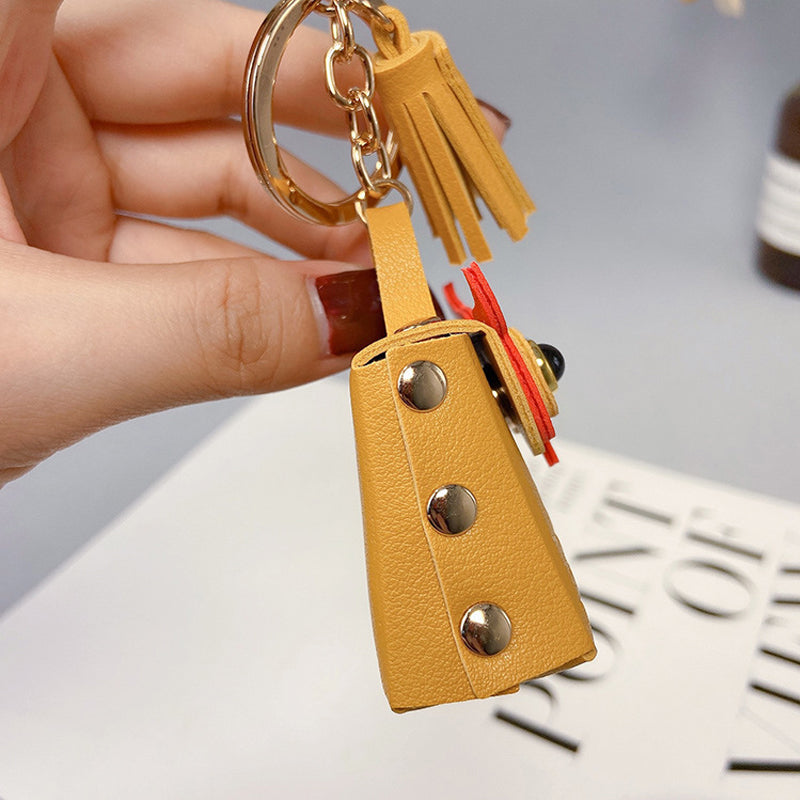 Detail shot of a pink mini handbag keychain's textured PU leather, a cute and practical accessory