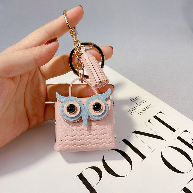 Group of colorful mini handbag keychains (pink, blue, yellow) showcasing variety and style