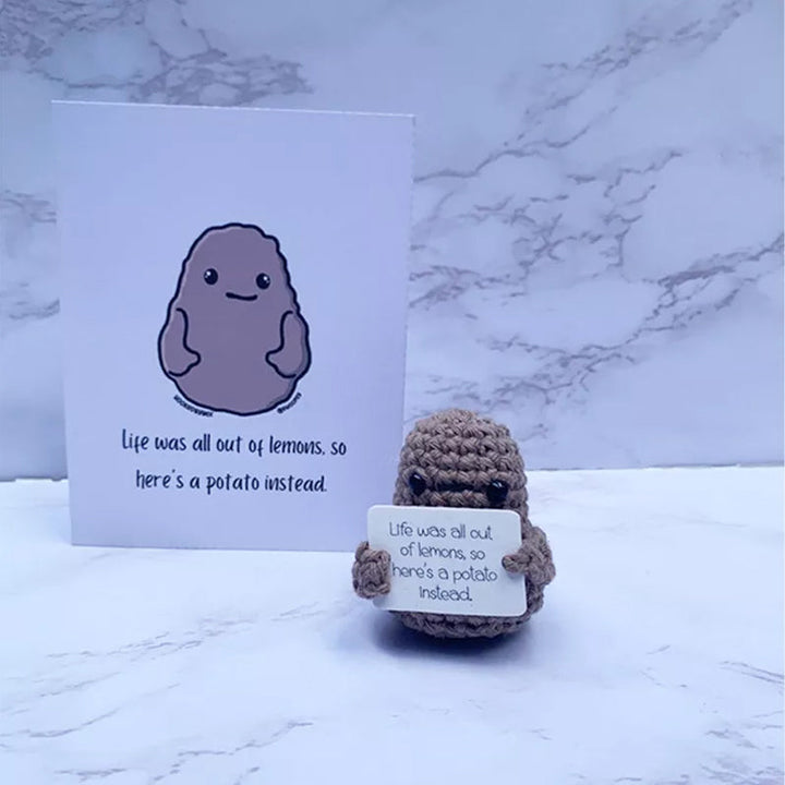 Soft focus shot of a positive potato knitted doll, highlighting its comforting presence and anxiety relief.