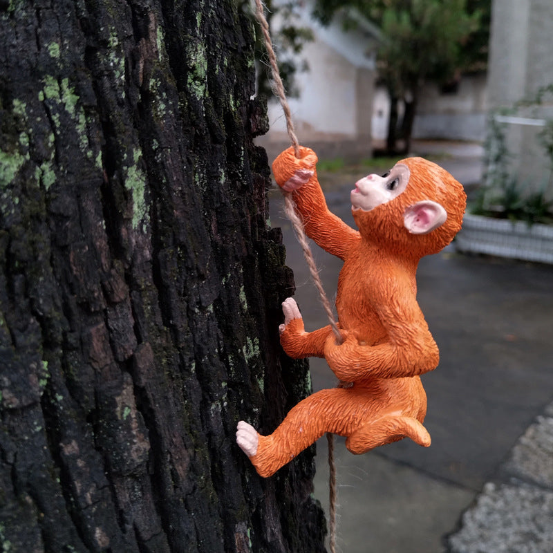 Playful raccoon tree hugger resin statue, a delightful animal ornament for garden trees.