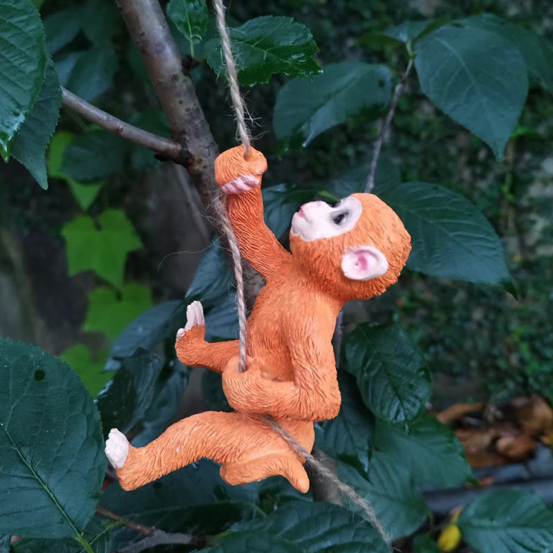 Detailed squirrel tree hugger resin statue, enhances backyard with outdoor animal decor.