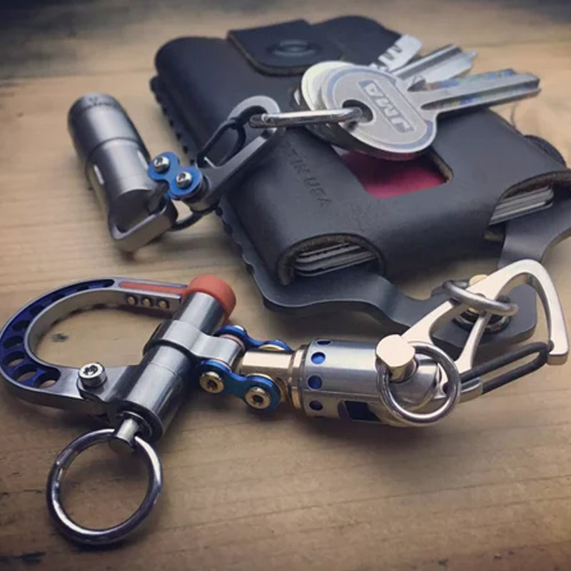 Black background studio shot of a cyberpunk metal keychain with several interchangeable components. Keywords: cyberpunk, keychain, metal