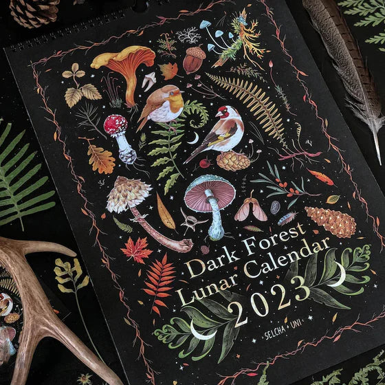 Dark Forest Lunar Calendar open to a spread, acting as a functional and aesthetic monthly planner