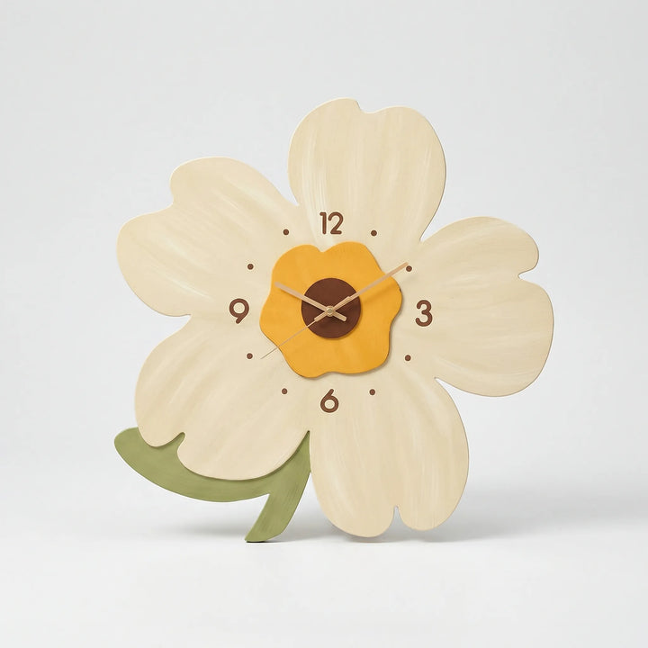 Large floral wall clock with orange and green petals, adds a pop of color to wall decor.