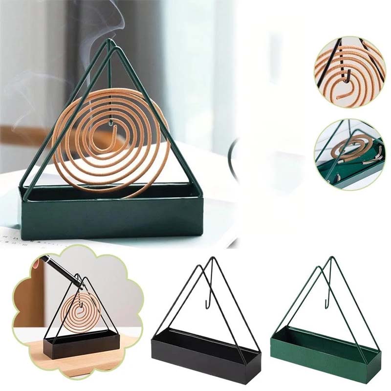 Decorative iron mosquito coil holder with intricate cutouts, safe and stylish for outdoor pest control.