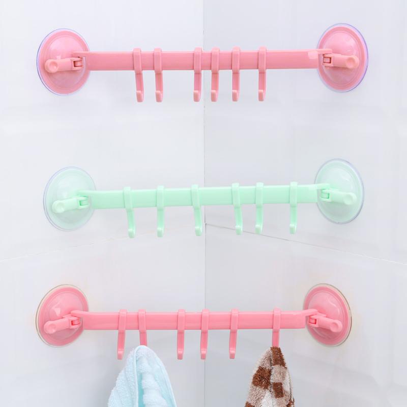 Set of clear detachable sucker hooks on a tile wall, perfect for kitchen utensils