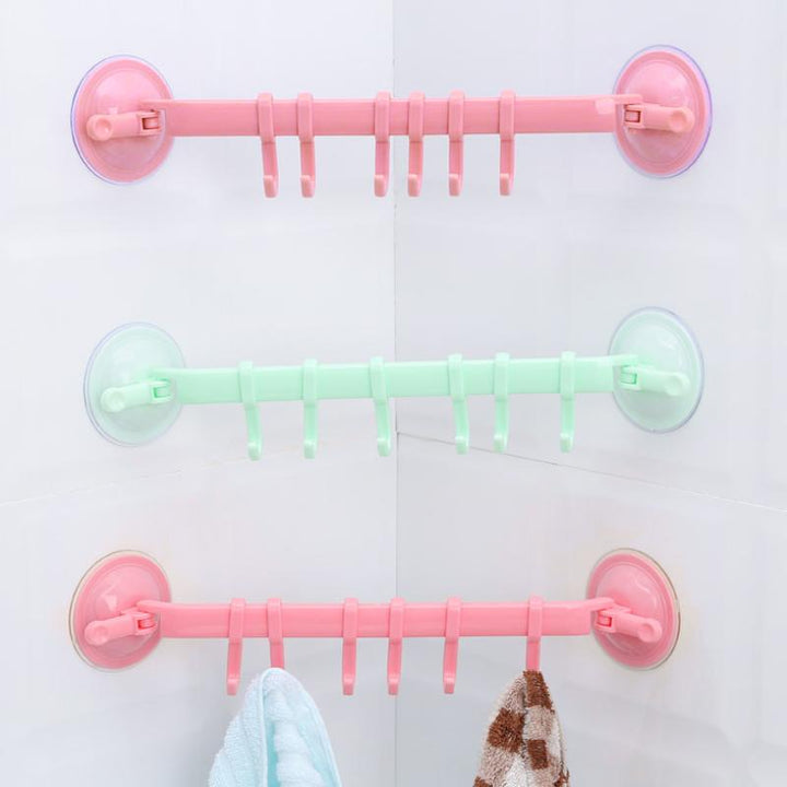 Set of clear detachable sucker hooks on a tile wall, perfect for kitchen utensils