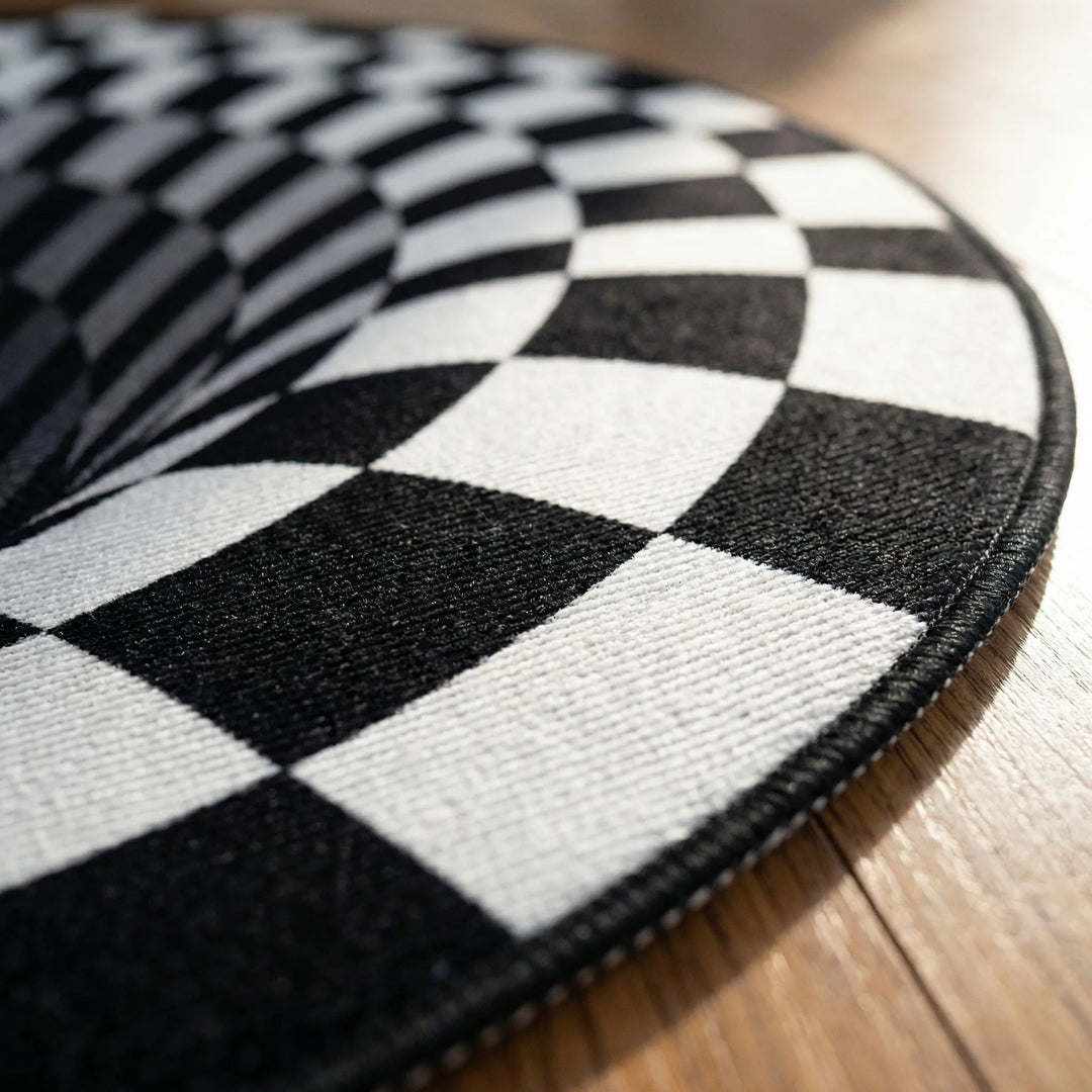Striking black & white 3D optical illusion vortex area rug. Modern round washable statement piece for home decor.