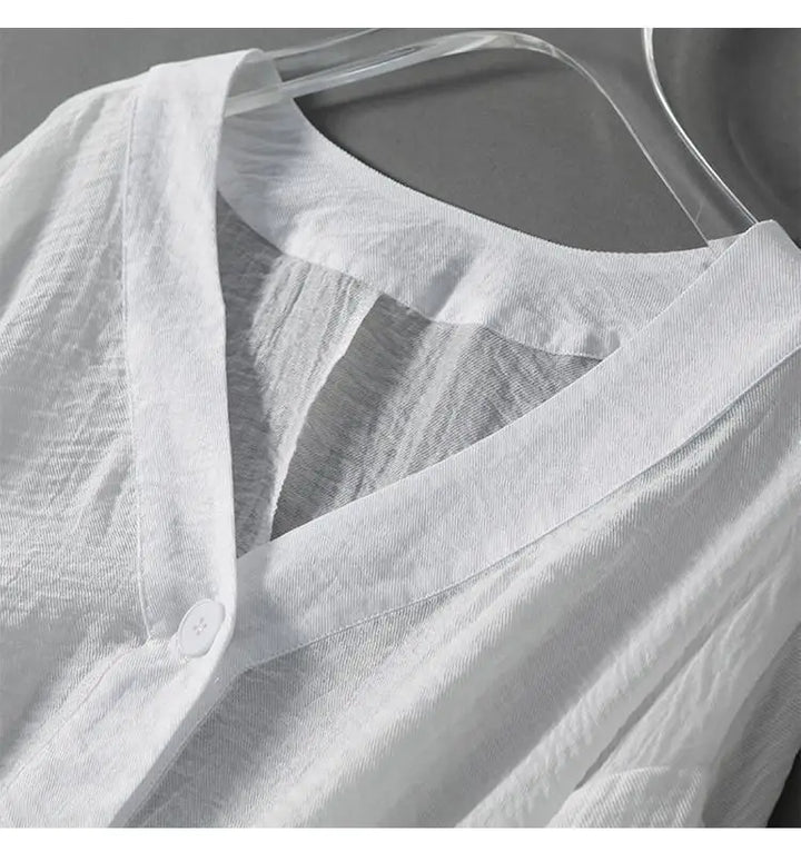Women's black summer blouse with elegant batwing sleeves, relaxed fit, and lightweight design for warm weather.