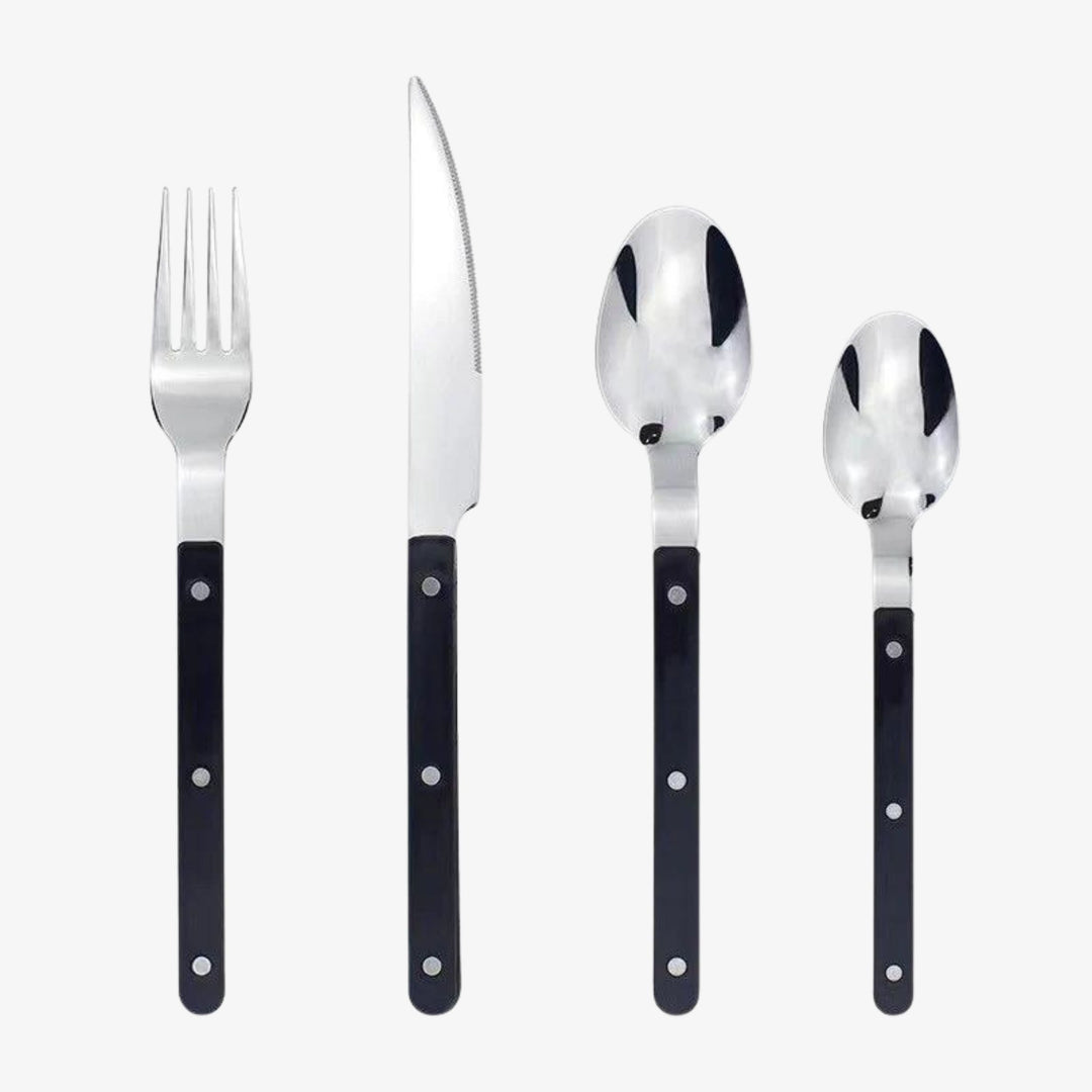 Elegant 24-piece stainless steel dining cutlery set with intricate engraved design for a sophisticated table setting.