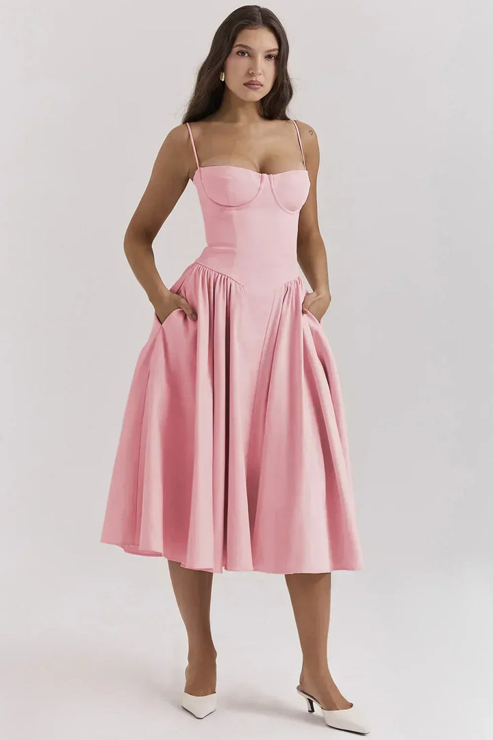 Amara special occasion women's midi dress with beautiful pleated hem and backless detail.