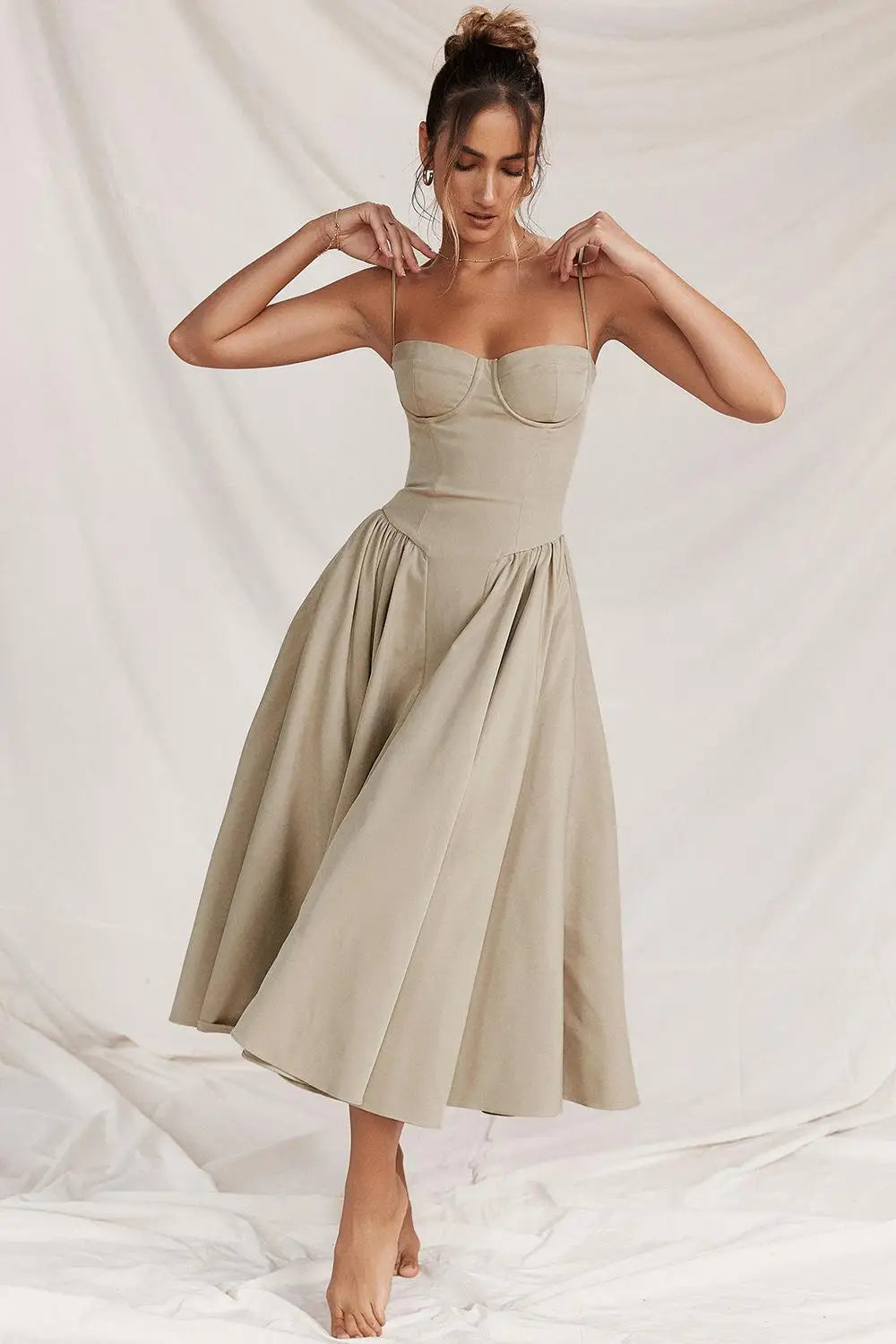 Stylish women's clothing: Amara midi dress with a pleated hem, ideal for special events.