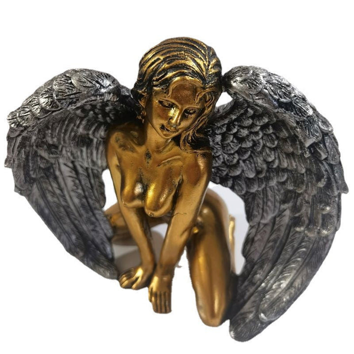 Angel wings kneeling figure against a neutral background, highlighting its delicate design