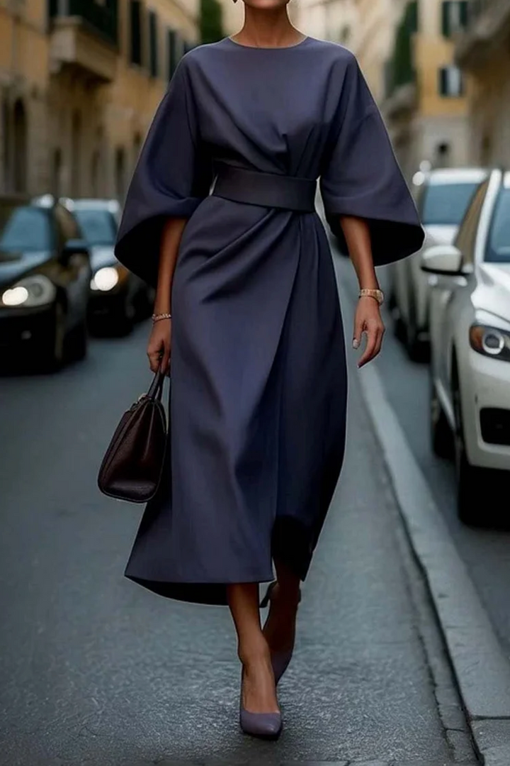 Women's sophisticated cocktail dress featuring a cinched waist belt and stylish lantern sleeves.