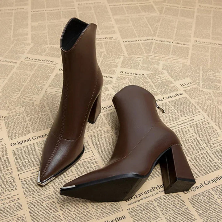 Stylish women's footwear: black ankle boots with a sharp pointed toe and stable block heel.