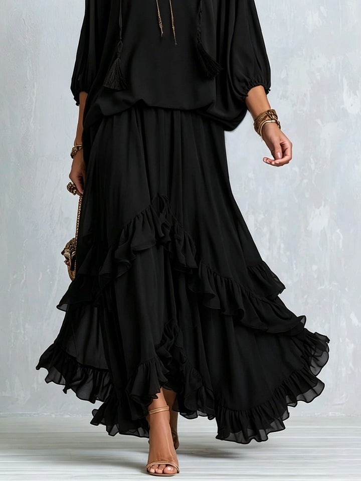 Stylish women's black boho matching set: V-neck top with lantern sleeves & elegant flowy tiered maxi skirt for summer.