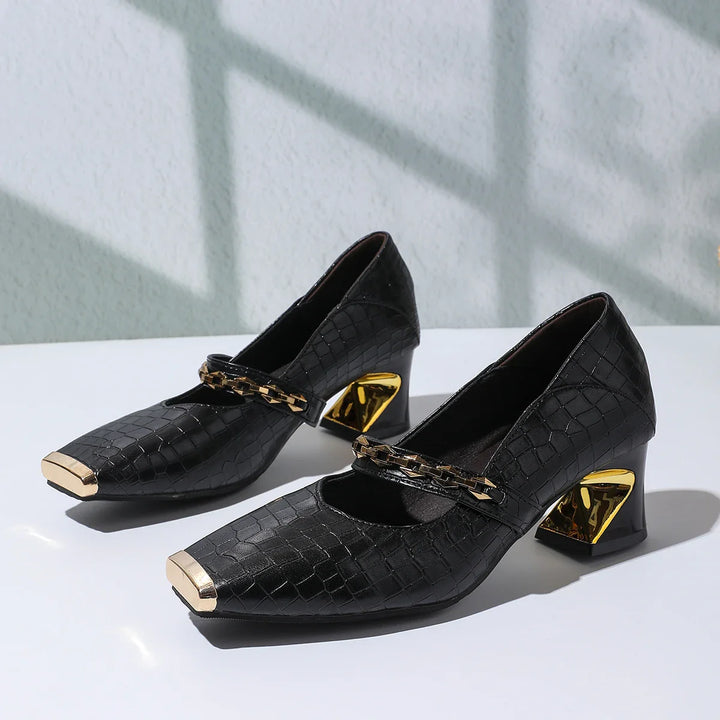 Elegant and comfortable women's bloc heel sandals made from faux leather, with a distinctive chain.