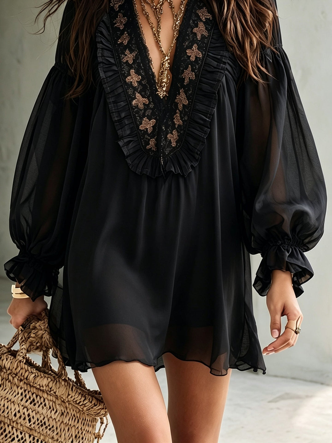 Boho-chic black V-neck mini dress with elegant balloon sleeves. Women's flowy party dress, perfect for evening wear.