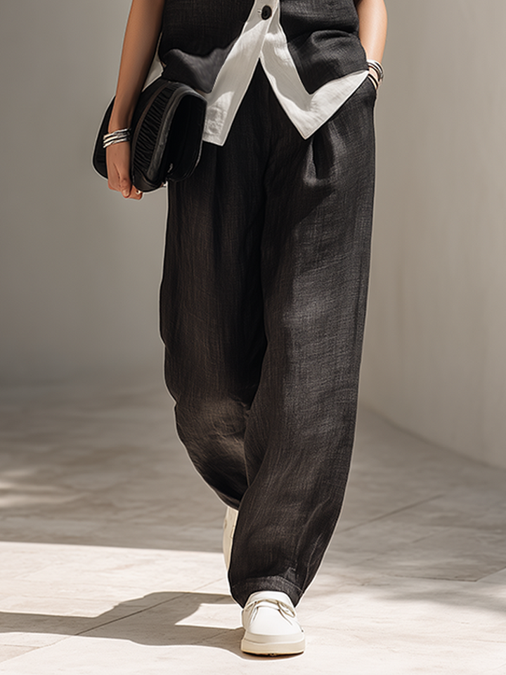 Modern women's black matching set featuring a stylish vest & comfortable wide-leg pants for a sleek, coordinated look.