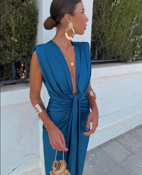 Elegant blue V-neck twist front maxi dress for wedding guests. Chic formal women's evening wear, perfect for special occasions.