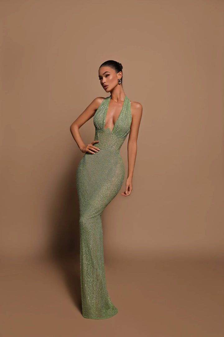 Women's flowy emerald maxi dress with an elegant silhouette, ideal for summer chic.