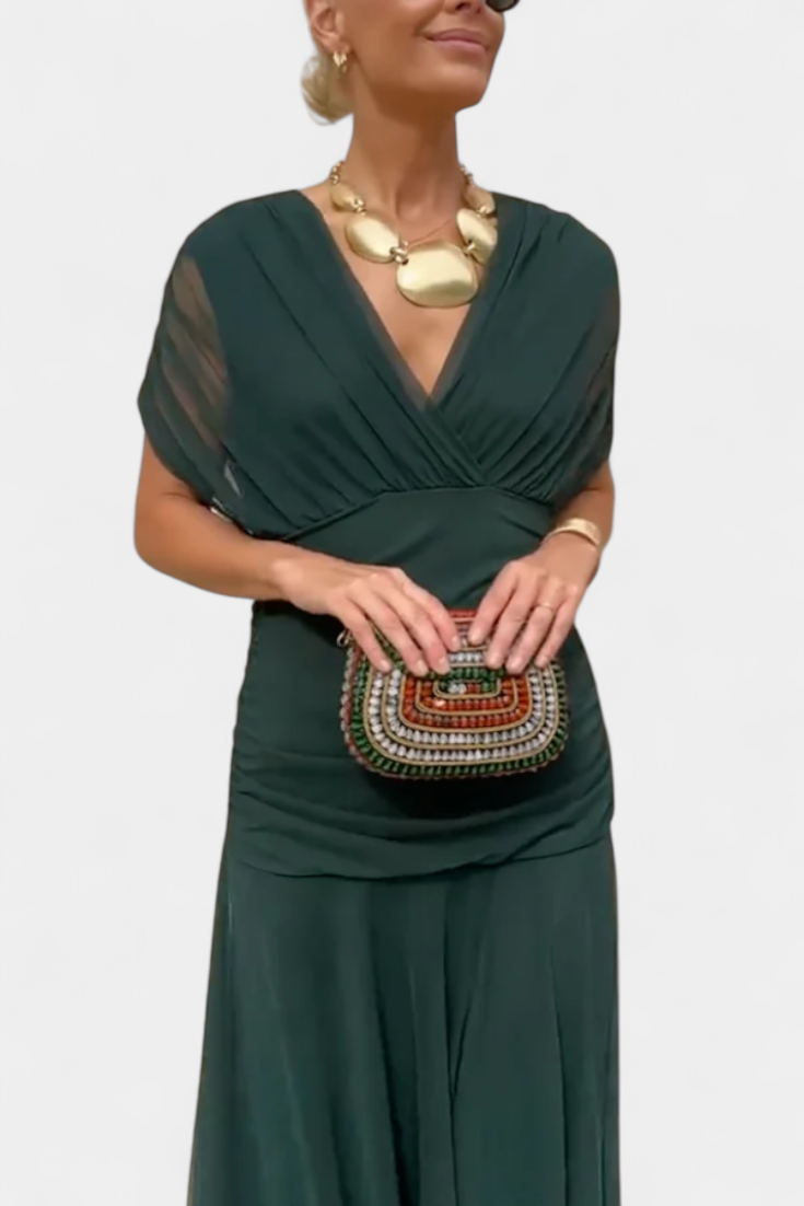 Stylish women's elegant floral maxi dress, showcasing a side view of its pleated waist and flowing design.