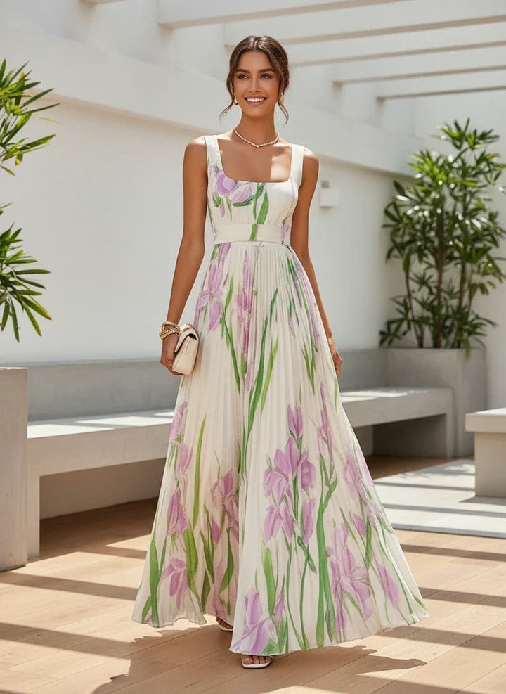 Summer wedding guest dress: elegant pleated maxi with floral print and square neck.