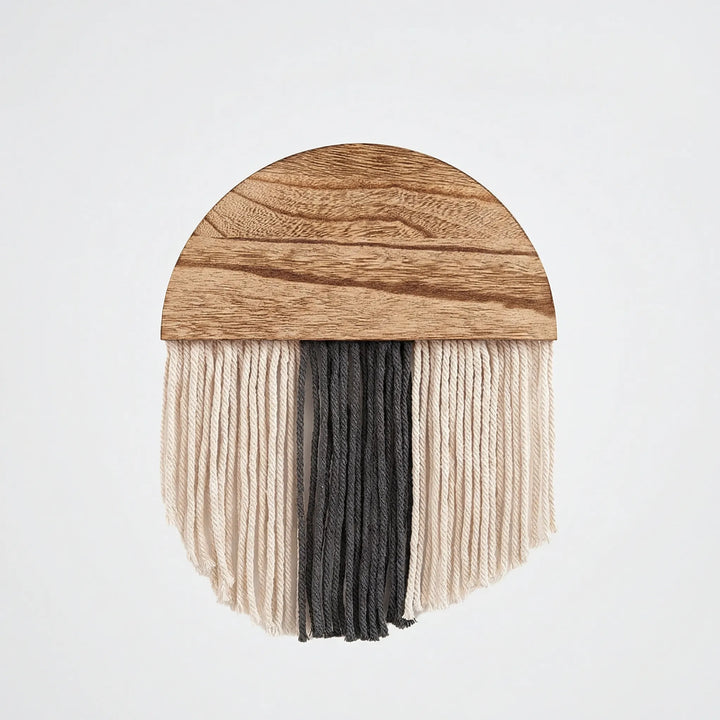 Statement half circle wall hanging with decorative fringe and wavy texture, enriching any home interior.