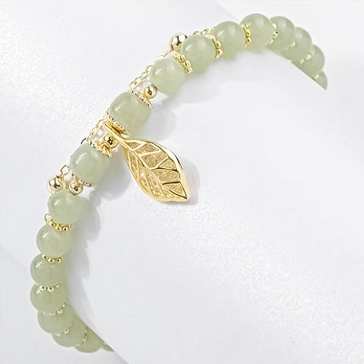 Sophisticated Hetian jade bracelet featuring unique gold leaf patterns, an elegant jewelry choice