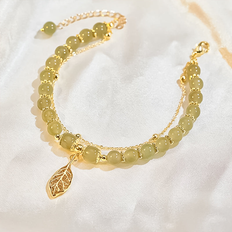 Stack of women's bracelets featuring a prominent Hetian jade and gold leaf design, trendy fashion