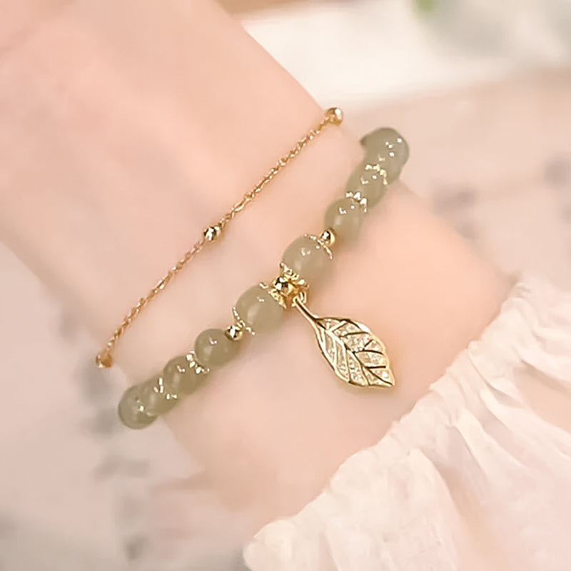 Glamorous women's Hetian jade bracelet with sparkling gold leaf, perfect for special occasions