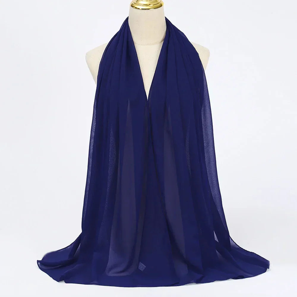 Dark blue elegant chiffon hijab scarf for women, a stylish head covering or fashion wrap.