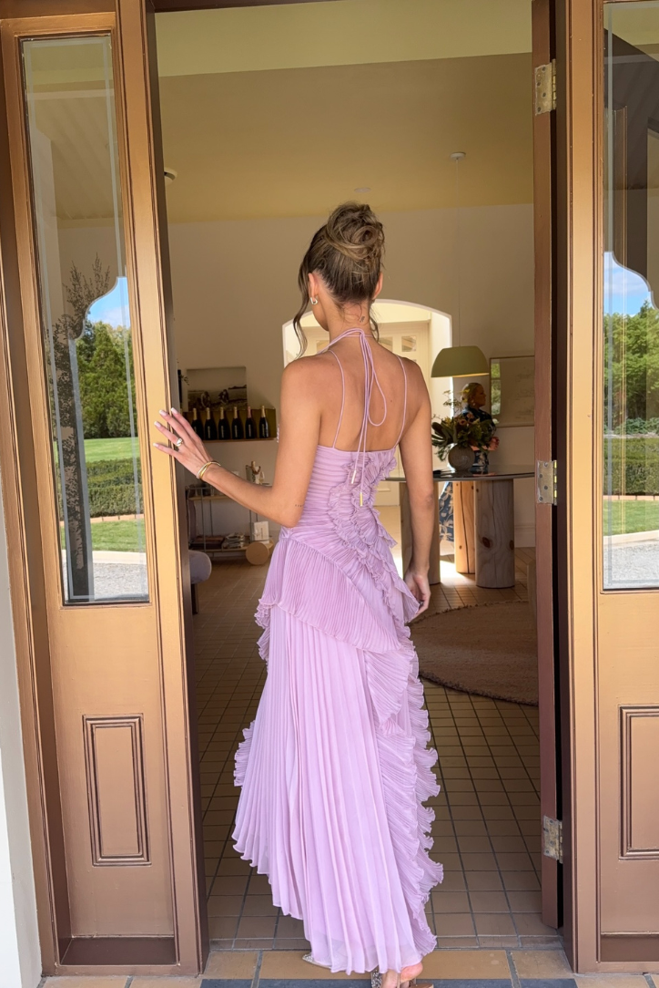 Graceful women's fashion: a chic lilac ruffled midi dress. Elegant sleeveless design for versatile summer style.