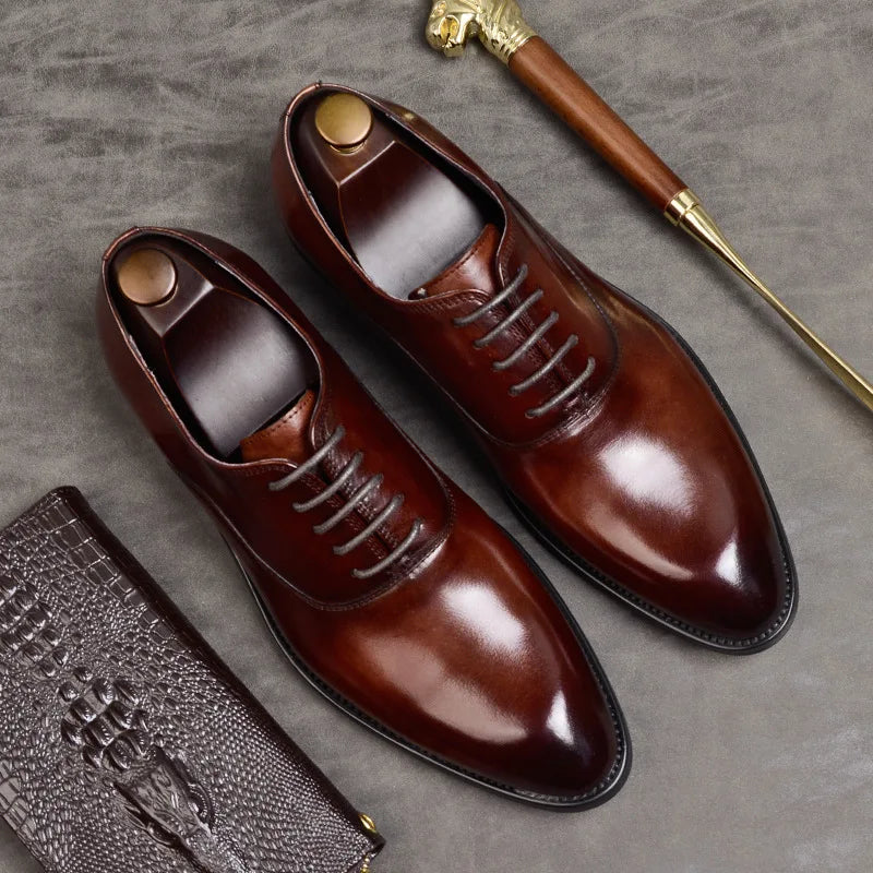 Elegant men's black leather Oxford dress shoes for formal events, business, or weddings. Classic lace-up design.