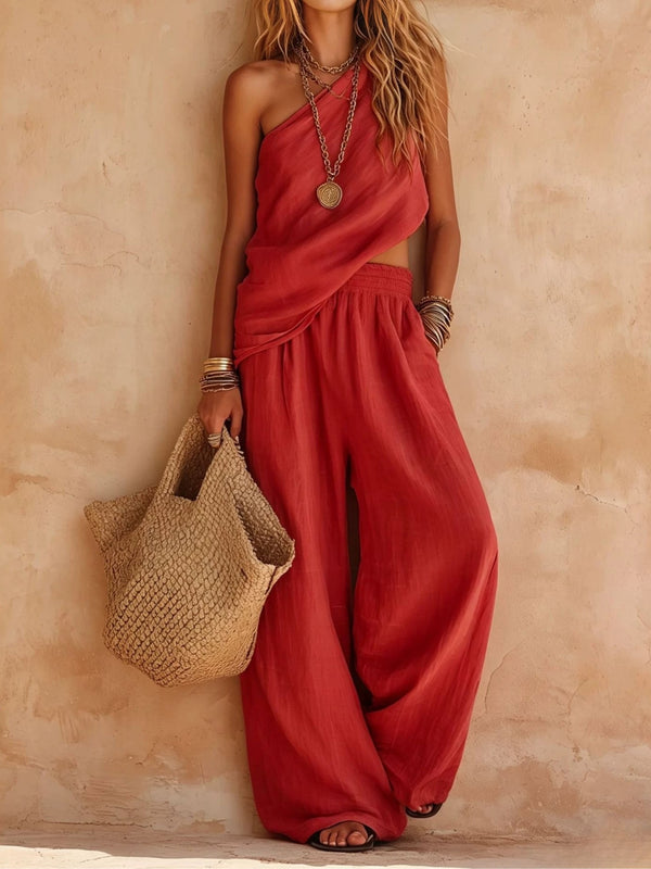 Women's elegant one-shoulder wide-leg jumpsuit. Flowing and draped, ideal for resort wear and parties.