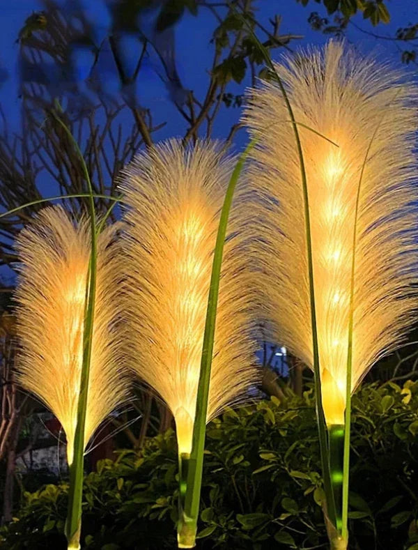 Elegant outdoor reed garden lights nestled among plants, perfect for decorative landscape lighting.
