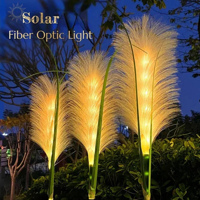 Reed-style pathway lights illuminating a garden path, creating a warm and inviting outdoor ambiance.