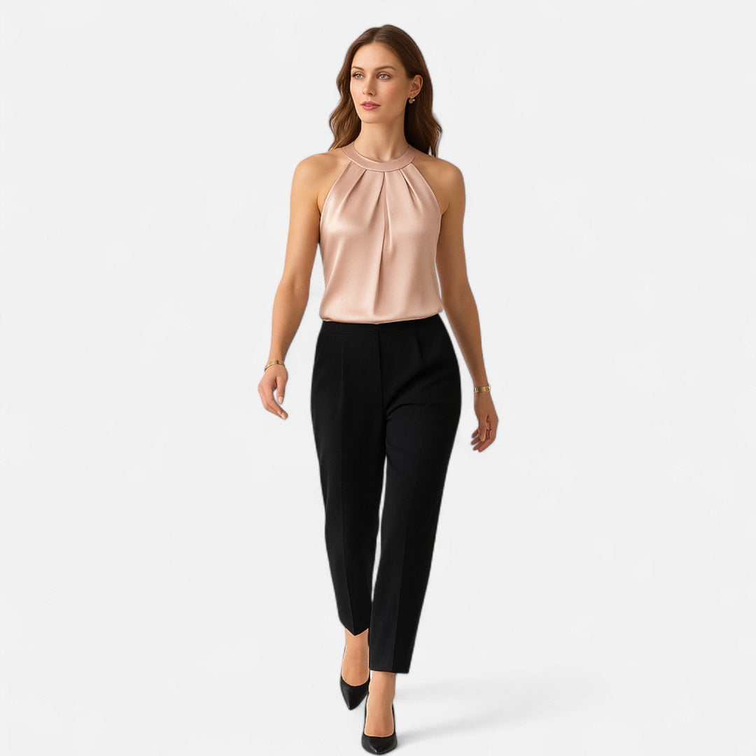 Sleeveless beige satin tank with elegant pleats and draped detailing, a stylish women's blouse.