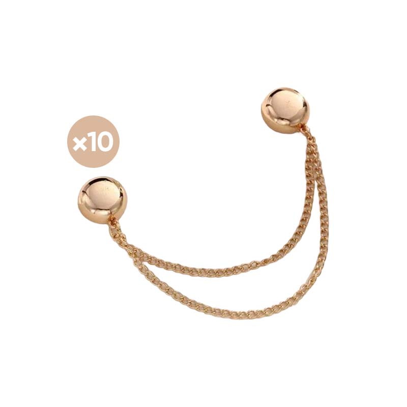 Woman's hand placing a magnetic clip on a silk blouse, demonstrating its gentle yet firm garment hold.