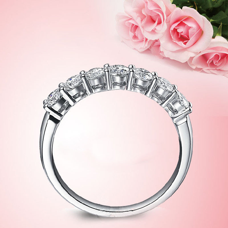 Side profile of an elegant seven diamond zircon ring, showing the setting craftsmanship.