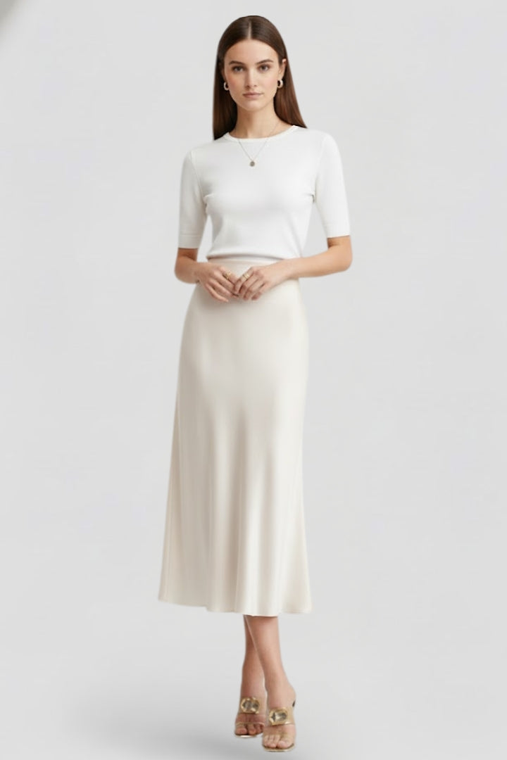 Sophisticated white midi skirt with high waist and elegant draping, ideal for occasion wear.