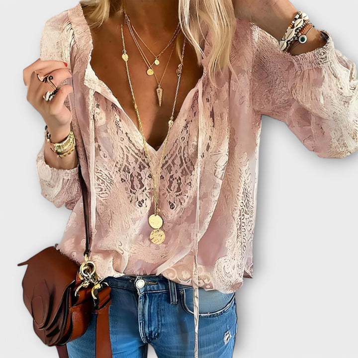 Chic women's tie-neck blouse with delicate details, an elegant and versatile top for casual or sophisticated looks.